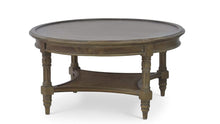 Load image into Gallery viewer, The Bramble Montego Round Coffee Table blends classic island-inspired design with refined craftsmanship. Built from solid mahogany, the table features a substantial round top supported by turned legs and a sculptural lower stretcher with woven rattan detailing that adds warmth, texture, and visual depth. Good Bones Furniture