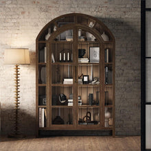 Load image into Gallery viewer, The Vannes 2 Door Display Cabinet from Bramble combines architectural scale with warm natural materials, creating a statement piece designed for both storage and display. Crafted from solid mahogany, the cabinet features a dramatic arched silhouette with glass-paneled doors framed in a rich contrasting finish that highlights the craftsmanship and curvature of the design. Good Bones Furniture