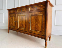 Load image into Gallery viewer, A study in balance and material, the Riley Sideboard draws from European neoclassical design—most notably Louis XVI—reimagined through a quieter, more modern lens. The form is clean and architectural, defined by symmetry, framed panels, and gently tapered legs that give the piece a sense of structure without excess. Cerejeira veneers are carefully bookmatched across each door, revealing a striking cathedral grain that brings movement and depth to the façade. Good Bones Furniture