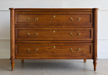 Load image into Gallery viewer, Gently used Ciborium chest by Sarreid showcases timeless European-inspired styling and exceptional craftsmanship. Constructed of solid walnut with a warm fruitwood finish, the piece features fluted corner columns, tapered turned legs, and three generously sized drawers accented with classic brass pulls and decorative faux keyhole escutcheons. Good Bones Furniture