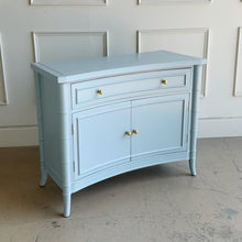 Load image into Gallery viewer, A wooden storage cabinet with a concave silhouette and faux bamboo accents, featuring a drawer and two cabinet doors.