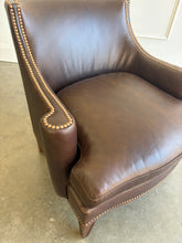 Load image into Gallery viewer, The Bentley Hall Leather Lounge Chair by Fairfield Chair combines rich materials, architectural lines, and exceptional comfort. Upholstered in deep chocolate brown leather, its sculptural tight back flows into sweeping arms outlined with antique brass nailhead trim. An ultra-plush loose seat cushion and high-resiliency back create an inviting place to relax, while arched spring construction provides lasting support. Tapered wood legs complete the timeless silhouette. Good Bones Furniture