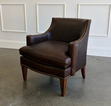 Load image into Gallery viewer, The Bentley Hall Leather Lounge Chair by Fairfield Chair combines rich materials, architectural lines, and exceptional comfort. Upholstered in deep chocolate brown leather, its sculptural tight back flows into sweeping arms outlined with antique brass nailhead trim. An ultra-plush loose seat cushion and high-resiliency back create an inviting place to relax, while arched spring construction provides lasting support. Tapered wood legs complete the timeless silhouette. Good Bones Furniture