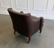 Load image into Gallery viewer, The Bentley Hall Leather Lounge Chair by Fairfield Chair combines rich materials, architectural lines, and exceptional comfort. Upholstered in deep chocolate brown leather, its sculptural tight back flows into sweeping arms outlined with antique brass nailhead trim. An ultra-plush loose seat cushion and high-resiliency back create an inviting place to relax, while arched spring construction provides lasting support. Tapered wood legs complete the timeless silhouette. Good Bones Furniture