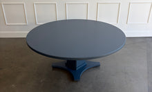 Load image into Gallery viewer, Inspired by Mid-Century design, the Maxwell Round Dining Table pairs clean architectural lines with softened curves for a look that feels modern yet timeless. Crafted from hand-selected oak solids and veneers, its generous 72-inch round top is supported by a substantial pedestal base with four gracefully curved feet. The table has been professionally lacquered by Good Bones Furniture in Farrow & Ball Hague Blue.