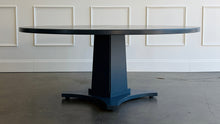 Load image into Gallery viewer, Inspired by Mid-Century design, the Maxwell Round Dining Table pairs clean architectural lines with softened curves for a look that feels modern yet timeless. Crafted from hand-selected oak solids and veneers, its generous 72-inch round top is supported by a substantial pedestal base with four gracefully curved feet. The table has been professionally lacquered by Good Bones Furniture in Farrow & Ball Hague Blue.
