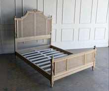 Load image into Gallery viewer, The Frontgate Beauvier French Cane Bed brings timeless Louis XVI style to the bedroom with elegant straight lines, classical ornament, and warm natural texture. Crafted from solid mahogany, it features handwoven double cane panels, twisted ribbon carving, floral swag and laurel wreath detailing, and beaded accents along the rails and finials. Good Bones Furniture