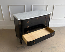Load image into Gallery viewer, This gently used Regency bow front chest by Frontgate brings classic glamour and tailored storage to the bedroom, entry, or living space. The glossy ebony finish is paired with a Carrara marble top, handpainted gold beading, and gold-accented corner carvings for a refined, high-contrast look. Good Bones Furniture