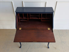 Load image into Gallery viewer, This vintage secretary desk has been professionally lacquered in Sherwin Williams Naval, giving the classic silhouette a rich, dramatic presence while preserving its traditional detailing and graceful cabriole legs. The drop-front desk opens to reveal a warm mahogany interior with divided compartments. Good Bones Furniture