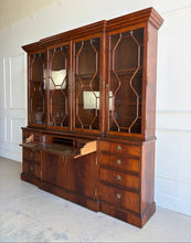 Load image into Gallery viewer, The Jonathan Charles Mahogany Breakfront Secretary Bookcase is a statement piece that combines the functionality of a library cabinet, secretary desk, display cabinet, and storage credenza in a single heirloom-quality design. Crafted with richly figured flame mahogany veneers, the cabinet showcases the level of craftsmanship that has made Jonathan Charles a respected name among collectors, designers, and luxury furniture retailers. Good Bones Furniture