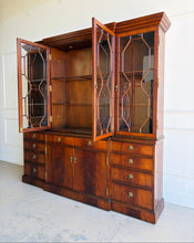 Load image into Gallery viewer, The Jonathan Charles Mahogany Breakfront Secretary Bookcase is a statement piece that combines the functionality of a library cabinet, secretary desk, display cabinet, and storage credenza in a single heirloom-quality design. Crafted with richly figured flame mahogany veneers, the cabinet showcases the level of craftsmanship that has made Jonathan Charles a respected name among collectors, designers, and luxury furniture retailers. Good Bones Furniture