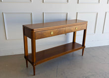 Load image into Gallery viewer, The Lipton 2 Drawer Console Table is a study in balance—combining classical detailing with a clean, tailored silhouette. Fluted legs, subtle carved accents, and a lower display shelf give the piece a refined, architectural presence, while the overall proportions keep it light and versatile. The drawer fronts are wrapped in richly figured cerejeira veneer. Good Bones Furniture