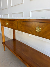 Load image into Gallery viewer, The Lipton 2 Drawer Console Table is a study in balance—combining classical detailing with a clean, tailored silhouette. Fluted legs, subtle carved accents, and a lower display shelf give the piece a refined, architectural presence, while the overall proportions keep it light and versatile. The drawer fronts are wrapped in richly figured cerejeira veneer. Good Bones Furniture