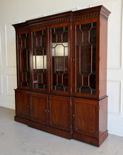 Load image into Gallery viewer, This Georgian-style breakfront china cabinet by Maitland Smith showcases the impeccable construction and richly figured mahogany the maker is known for. The upper cabinet features an illuminated interior behind glass-paneled doors, with adjustable glass shelves that beautifully display china, books, or collected objects. The top is made in three separate sections for easier transport and installation. Good Bones Furniture