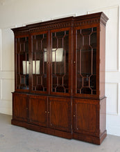 Load image into Gallery viewer, This Georgian-style breakfront china cabinet by Maitland Smith showcases the impeccable construction and richly figured mahogany the maker is known for. The upper cabinet features an illuminated interior behind glass-paneled doors, with adjustable glass shelves that beautifully display china, books, or collected objects. The top is made in three separate sections for easier transport and installation. Good Bones Furniture