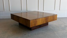 Load image into Gallery viewer, The Margo Square Coffee Table makes an impact through proportion, material, and simplicity. Its low, architectural profile gives it a grounded presence, while the richly figured veneer brings warmth and movement across the broad square top. Set on a recessed base, the silhouette feels clean and modern with a subtle floating effect. Good Bones Furniture
