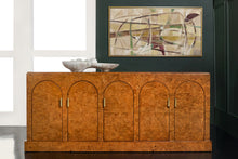 Load image into Gallery viewer, The Modern History Arches Credenza is a striking statement piece defined by rich material and architectural form. Wrapped in dramatic Ashe burl veneer, the surface reveals intricate swirling grain patterns that create depth and visual movement across the entire façade. A sequence of softly arched doors gives the cabinet its signature rhythm, adding sculptural interest while maintaining a clean, tailored silhouette. Good Bones Furniture