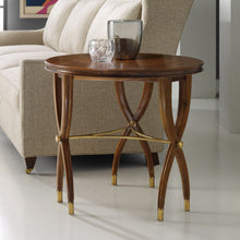 Load image into Gallery viewer, The Modern History Marchand End Table combines refined craftsmanship with sculptural design. A beautifully figured walnut veneer top showcases rich grain variation arranged in a radial pattern, giving the surface visual depth and warmth. The table’s elegant curved legs intersect with a brass stretcher, creating an architectural base that feels both light and structurally balanced. Good Bones Furniture