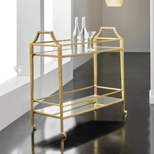Load image into Gallery viewer, Elevate your entertaining space with the Modern History Shagreen Bar Cart, a luxurious blend of unique textures and timeless materials. Its distinctive brass shagreen texture immediately catches the eye, offering a sophisticated tactile element that sets it apart from ordinary bar carts. Above, a clear glass top provides a pristine, elegant surface to showcase your finest spirits and glassware, while below, an antique mirror glass base adds depth, subtle shimmer, and a hint of old-world glamour.
