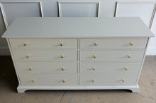 Load image into Gallery viewer, A timeless Newport Cabinet Company dresser professionally refinished in Benjamin Moore Natural Cream, creating a fresh, sophisticated look while preserving its exceptional craftsmanship. Featuring eight generously sized drawers, this dresser offers abundant storage with clean, tailored lines that complement both traditional and transitional interiors. Good Bones Furniture