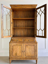 Load image into Gallery viewer, Elevate your dining or living space with the timeless elegance of the Rosalind China Cabinet. Handcrafted from solid mango wood and mango wood veneers, this cabinet combines durability with natural beauty, showcasing the wood's rich, warm tones and unique grain patterns. Its sleek design is complemented by solid brass hardware, adding a touch of refined sophistication. Good Bones Furniture