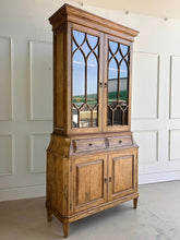 Load image into Gallery viewer, Elevate your dining or living space with the timeless elegance of the Rosalind China Cabinet. Handcrafted from solid mango wood and mango wood veneers, this cabinet combines durability with natural beauty, showcasing the wood's rich, warm tones and unique grain patterns. Its sleek design is complemented by solid brass hardware, adding a touch of refined sophistication. Good Bones Furniture