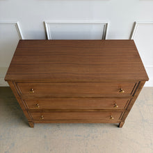 Load image into Gallery viewer, The Sherrill Occasional 3 Drawer Single Dresser offers clean transitional styling with refined materials and balanced proportions. Crafted from maple solids and quartered walnut veneers, this piece showcases subtle linear grain movement enhanced by the warm Cashew finish. Good Bones Furniture