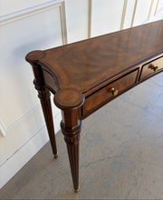 Load image into Gallery viewer, Close-up of the Theodore Alexander Grandinson console top highlighting flame walnut veneer, yew burl crossbanding, and softly concave edges inspired by Regency design