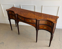 Load image into Gallery viewer, Angled left top view of the Theodore Alexander Stanhope Row Sideboard highlighting the richly figured flame veneer, morado crossbanding, and sculptural contours, available from Good Bones Furniture in Raleigh, North Carolina.