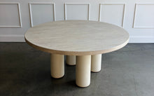 Load image into Gallery viewer, The Maxwell Round Dining Table by Theodore Alexander combines natural oak grain with distinctive shagreen texture and an architectural silhouette. Crafted from oak wood and oak veneers, the generous round top is finished in pale Cashmere, allowing its organic grain to remain visible. Four cylindrical supports feature a subtle shagreen surface in a tonal Dove finish. Good Bones Furniture