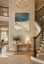 Load image into Gallery viewer, Not So Layered 1 by Theodore Alexander is a large-scale abstract landscape that explores the natural world through broad, expressive fields of color. A commanding Prussian-blue sky anchors the upper canvas, while sweeping layers of ivory, soft green, muted lavender, and pale blue suggest an atmospheric landscape below. Visible brushwork and translucent washes create texture, movement, and depth throughout the composition. Good Bones Furniture