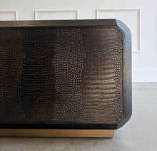 Load image into Gallery viewer, The Spencer St. James Square Cocktail Table by Theodore Alexander combines bold contemporary form with richly tactile materials. Crafted from oak wood and crocodile-embossed leather, its substantial square silhouette features clipped corners that soften the strong architectural lines. Good Bones Furniture