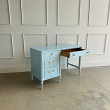 Load image into Gallery viewer, Thomasville vintage writing desk with drawer open, revealing solid wood interior storage and smooth function beneath a Billowy Breeze blue lacquer finish and updated brass hardware