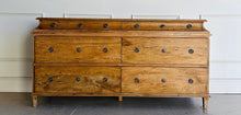 Load image into Gallery viewer, Built from solid mango wood, the Valencia dresser mixes timeless European lines with a relaxed, hand-finished patina. A stepped gallery crowns the case, while framed drawer fronts and reeded, tapered feet give the piece architectural presence. At 72" wide with six generous drawers, it brings warm, natural character and serious storage to the primary bedroom, guest suite, or sophisticated entry.