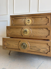Load image into Gallery viewer, This handsome six-drawer dresser by Vanguard Furniture blends tailored lines with refined transitional styling. Crafted with beautifully grained oak veneers, it features sculpted drawer fronts, oversized antiqued brass ring pulls, and elegantly tapered legs that give the piece a sophisticated presence. Good Bones Furniture