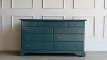 Load image into Gallery viewer, This vintage solid wood 9-drawer dresser has been professionally lacquered in Farrow & Ball Inchyra Blue, a refined blue-green tone that brings depth and understated drama to any room. The clean, traditional lines pair beautifully with new lucite and brass handles, creating a balanced look that feels both classic and freshly updated. Each drawer offers generous storage, making this a functional statement piece for bedrooms, entryways, or living spaces. Good Bones Furniture