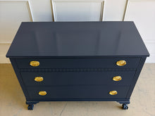 Load image into Gallery viewer, Classic craftsmanship meets a bold designer finish in this vintage ball and claw chest, professionally lacquered in Benjamin Moore In the Navy. The rich navy finish highlights the elegant fluted corner details, carved ball and claw feet, and decorative geometric molding across the upper drawer, while new solid brass Hepplewhite drawer pulls add a timeless finishing touch. Good Bones Furniture