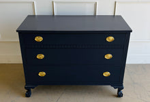 Load image into Gallery viewer, Classic craftsmanship meets a bold designer finish in this vintage ball and claw chest, professionally lacquered in Benjamin Moore In the Navy. The rich navy finish highlights the elegant fluted corner details, carved ball and claw feet, and decorative geometric molding across the upper drawer, while new solid brass Hepplewhite drawer pulls add a timeless finishing touch. Good Bones Furniture