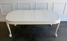 Load image into Gallery viewer, This vintage Chippendale-style dining table combines elaborate traditional detailing with a fresh, versatile finish. Professionally lacquered in Benjamin Moore Swiss Coffee darkened by 50%, it has a warm, creamy white appearance that highlights its carved details without feeling stark. Good Bones Furniture