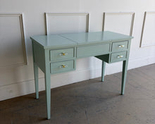 Load image into Gallery viewer, This vintage Craftique vanity has been professionally refinished in a custom light teal lacquer, giving the classic form a fresh, tailored look. Clean lines and tapered legs reflect the refined simplicity Craftique furniture is known for, while new lucite and brass hardware adds a subtle touch of modern glamour. Good Bones Furniture