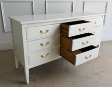 Load image into Gallery viewer, Vintage 9 drawer dresser by Dixie Furniture offers substantial storage within a timeless, beautifully proportioned silhouette. Professionally lacquered in Benjamin Moore Swiss Coffee at 150% strength, its warm creamy-white finish highlights the clean lines, inset drawer fronts, and tapered legs. Good Bones Furniture