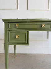 Load image into Gallery viewer, Vintage desk by Drexel Furniture combines practical workspace with timeless architectural detailing. Professionally lacquered in Farrow & Ball Bancha, its earthy olive-green finish highlights the framed drawer fronts, inset desktop border, and slender tapered legs. Four drawers, original polished brass hardware and brass-capped feet. Good Bones Furniture