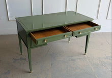 Load image into Gallery viewer, Vintage desk by Drexel Furniture combines practical workspace with timeless architectural detailing. Professionally lacquered in Farrow & Ball Bancha, its earthy olive-green finish highlights the framed drawer fronts, inset desktop border, and slender tapered legs. Four drawers, original polished brass hardware and brass-capped feet. Good Bones Furniture