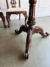 Load image into Gallery viewer, This vintage Drexel Heritage Nine Elms dining set showcases richly figured crotch mahogany veneer framed by contrasting banding. The expansive table rests on two ornately carved pedestal bases and includes three 22-inch leaves, extending it to an impressive 140 inches for large gatherings. Eight coordinating chairs—two armchairs and six side chairs. Good Bones Furniture