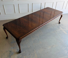 Load image into Gallery viewer, A timeless Henredon dining table crafted with exceptional attention to detail and beautiful figured mahogany veneers. The richly grained top showcases dramatic cathedral patterns framed by a contrasting mahogany border, while the carved cabriole legs with ball-and-claw feet reflect classic Chippendale-inspired design. Good Bones Furniture