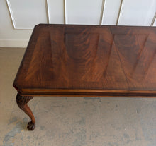 Load image into Gallery viewer, A timeless Henredon dining table crafted with exceptional attention to detail and beautiful figured mahogany veneers. The richly grained top showcases dramatic cathedral patterns framed by a contrasting mahogany border, while the carved cabriole legs with ball-and-claw feet reflect classic Chippendale-inspired design. Good Bones Furniture