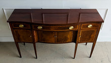 Load image into Gallery viewer, Vintage Hickory Chair sideboard showcasing classic Federal-inspired styling with beautifully banded mahogany veneers, graceful serpentine lines, and tapered legs. The thoughtfully designed layout includes three drawers above three cabinet compartments, offering versatile storage for dining essentials, serving pieces, or barware. Rich mahogany grain, satin brass hardware, and refined inlay details. Good Bones Furniture