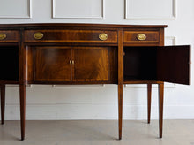 Load image into Gallery viewer, Vintage Hickory Chair sideboard showcasing classic Federal-inspired styling with beautifully banded mahogany veneers, graceful serpentine lines, and tapered legs. The thoughtfully designed layout includes three drawers above three cabinet compartments, offering versatile storage for dining essentials, serving pieces, or barware. Rich mahogany grain, satin brass hardware, and refined inlay details. Good Bones Furniture