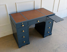 Load image into Gallery viewer, This vintage desk has been professionally lacquered in Farrow & Ball Hague Blue, giving the classic form a rich, tailored presence. The leather inset top adds warmth and contrast, while new brass knobs provide a refined finishing touch. Good Bones Furniture