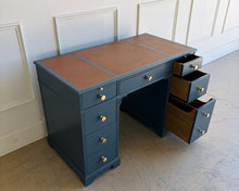 Load image into Gallery viewer, This vintage desk has been professionally lacquered in Farrow & Ball Hague Blue, giving the classic form a rich, tailored presence. The leather inset top adds warmth and contrast, while new brass knobs provide a refined finishing touch. Good Bones Furniture